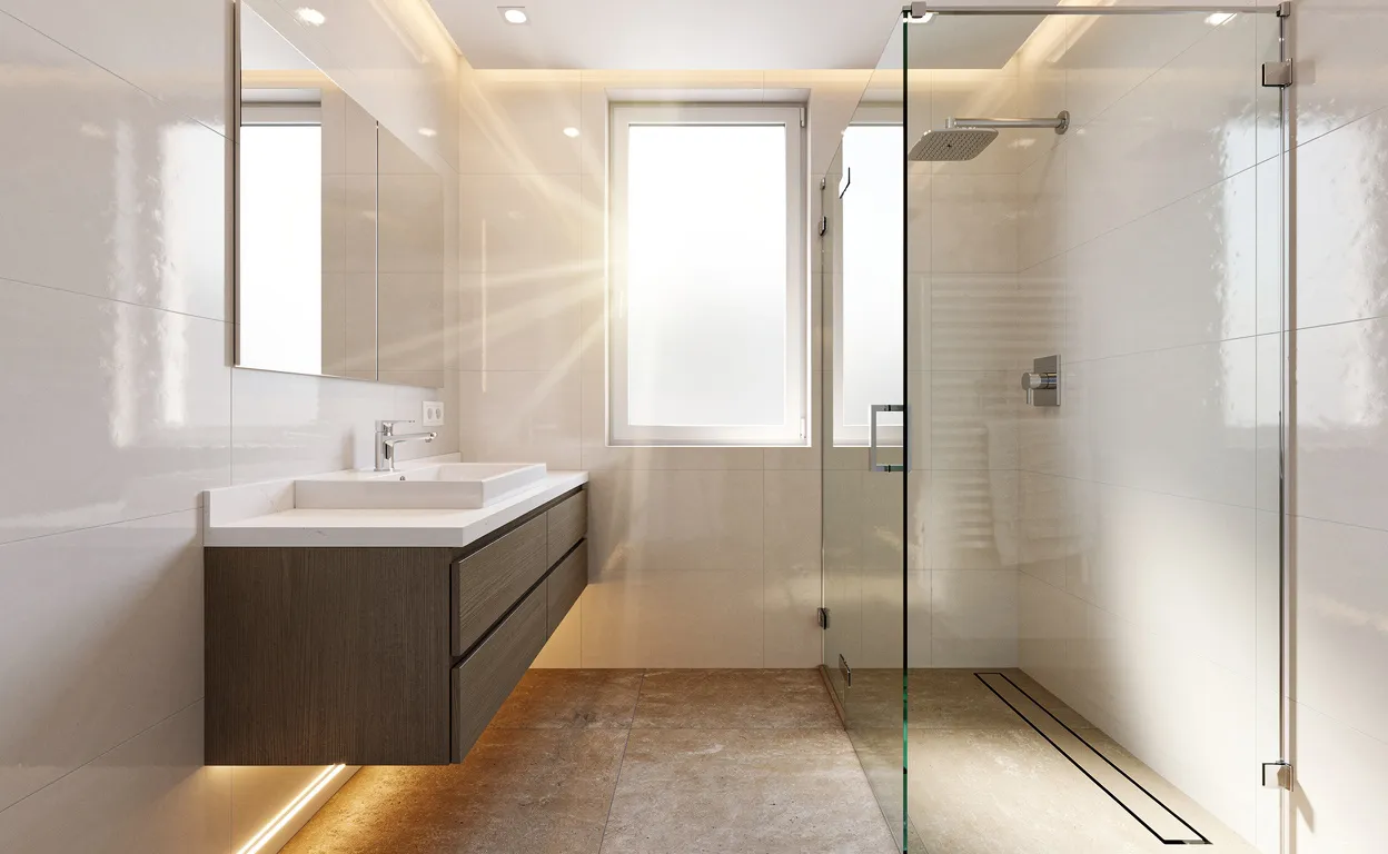 Salle de bain de 4m2 avec douche vitrée, meuble suspendu, carrelage clair et lumière naturelle traversant une fenêtre dépolie.